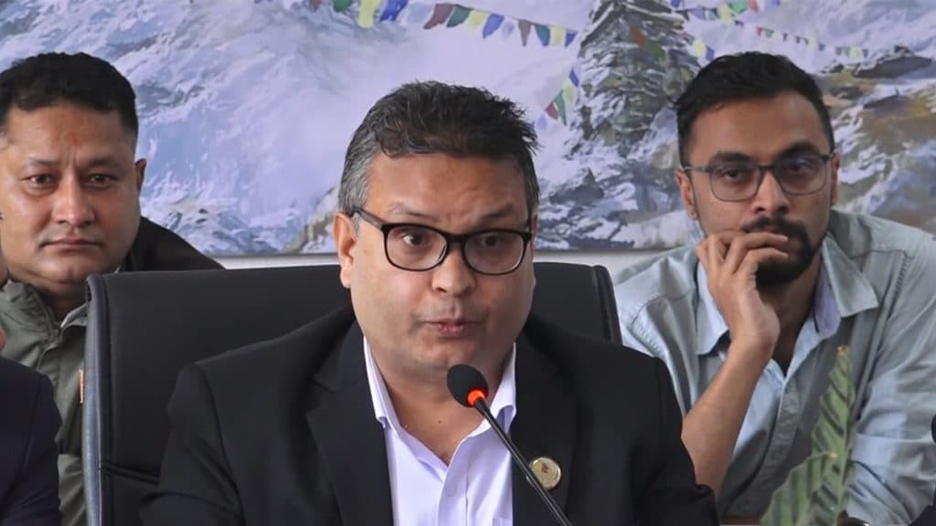 A parliamentary committee leader speaks into a microphone during a meeting on capital market governance.