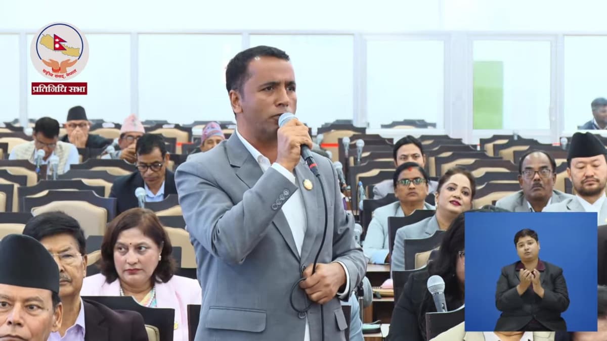 Yuvraj Dulal speaking into a microphone during a session of the House of Representatives.