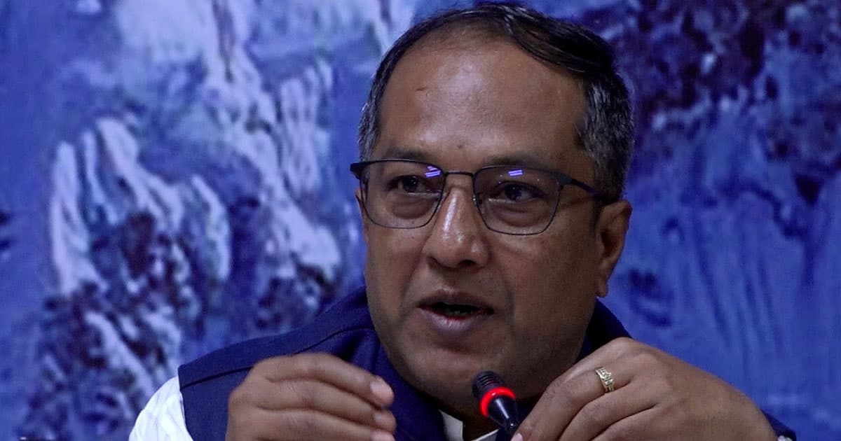 Minister for Industry, Commerce and Supplies Deepak Kumar Sah speaks into a microphone.