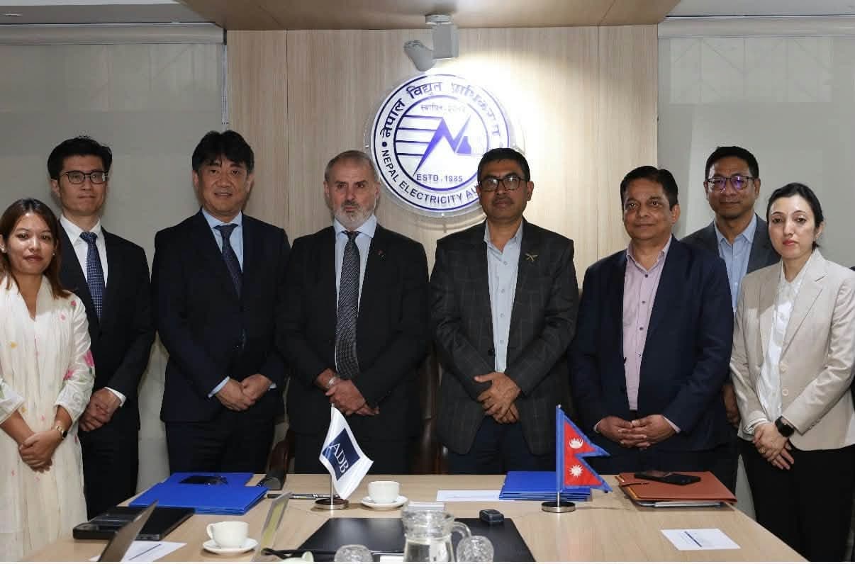 Nepal Electricity Authority and Asian Development Bank officials stand together after signing a transaction advisory agreement.