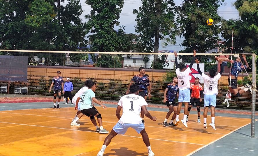 Players from Nepal Police Club and Manimukunda Volleyball Club contest the ball at the net during a tournament match in Butwal.