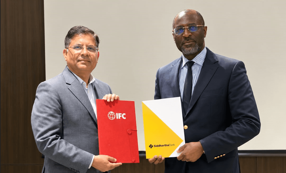 Officials from Siddhartha Bank and the IFC pose with signed partnership documents.