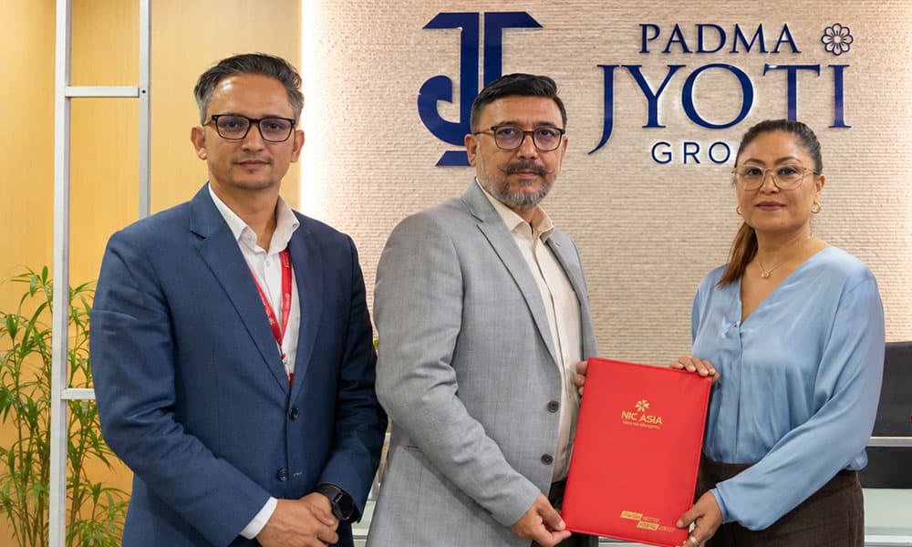 Syakar Trading CEO Srijana Jyoti and NIC Asia Bank officials hold a red folder after signing a vehicle financing agreement.