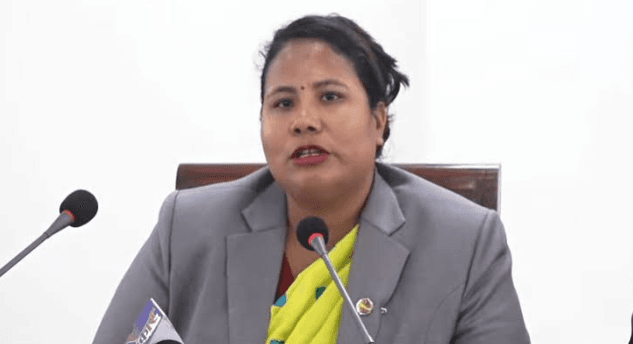 Minister for Agriculture, Forests and Environment Gita Chaudhary speaking behind microphones.