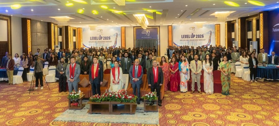 National Life Insurance executives and workshop participants standing in a conference hall in Nepalgunj.