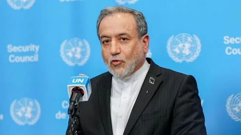 Iranian Foreign Minister Abbas Araghchi speaking into a microphone at the United Nations.
