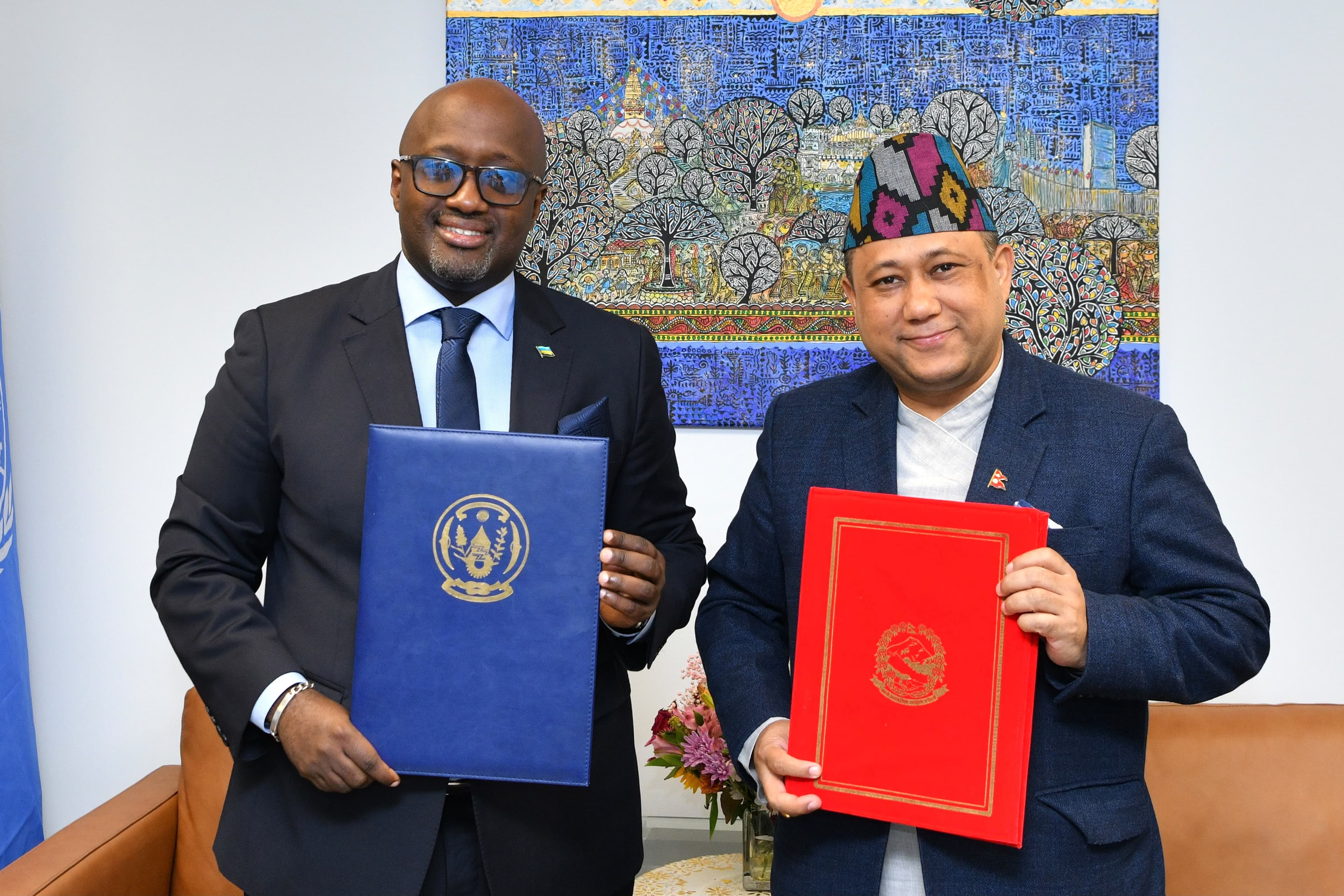 Foreign Minister Shishir Khanal and Rwandan Foreign Minister Olivier Nduhungirehe hold up signed bilateral agreement folders in New York.