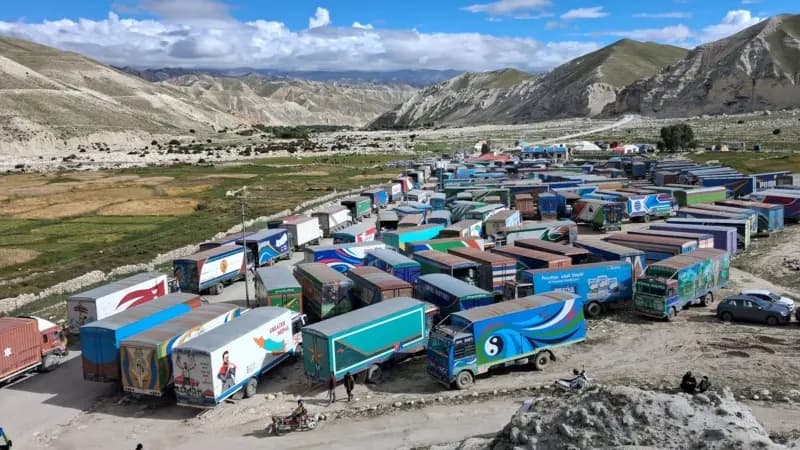 Dozens of cargo trucks stranded in an arid mountain basin at the Korala border crossing in Upper Mustang.