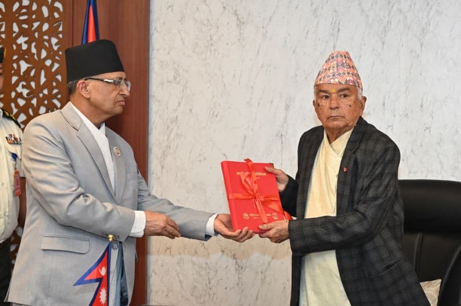 Acting Chairperson Hari Dutta Joshi handing over the annual report to President Ramchandra Paudel.