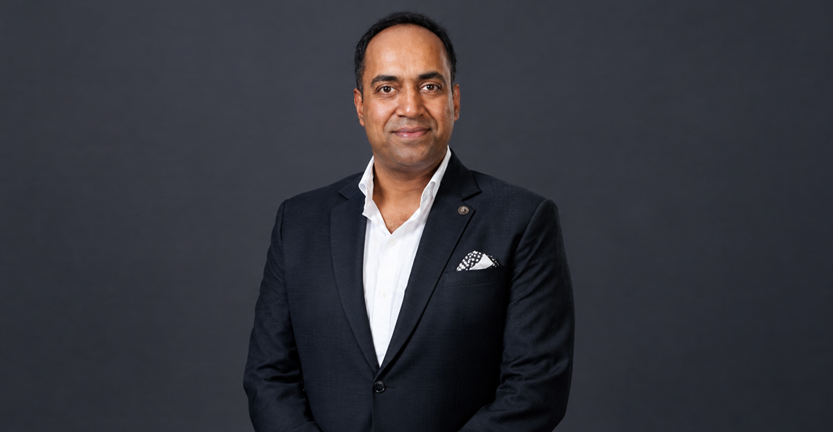 Portrait of industrialist Amit Mor dressed in a black suit with a pocket square.