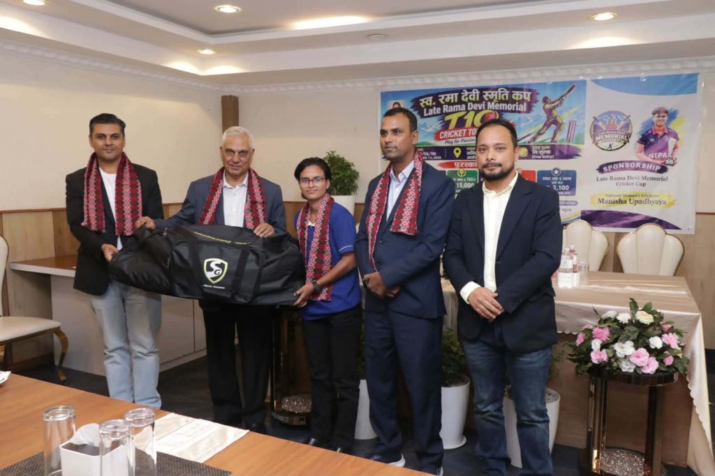 Nepali cricketer Manisha Upadhyay receives a cricket equipment kit bag from tournament officials.